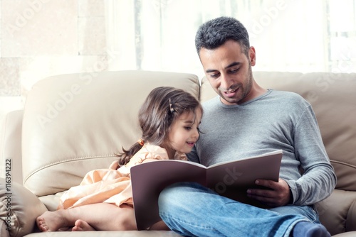 Fotografija  Little Girl And Father Reading Book Together