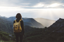 Hipster Girl With Backpack Enjoying Sunset On Peak Foggy Mountain. Tourist Traveler On Background Valley Landscape View Mockup. Hiker Looking Sunlight In Trip Northern Spain Picos De Europa Mock Up