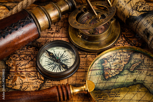 Obraz na płótnie Old vintage compass and travel instruments on ancient map