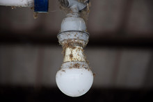Old Dusty Light Bulb In Power Off.