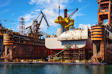 Wall Mural - Big ship under repairing on floating dry dock in shipyard.