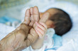 © DN6 - Close up baby hands holding grandmother (Soft focus and blurry)