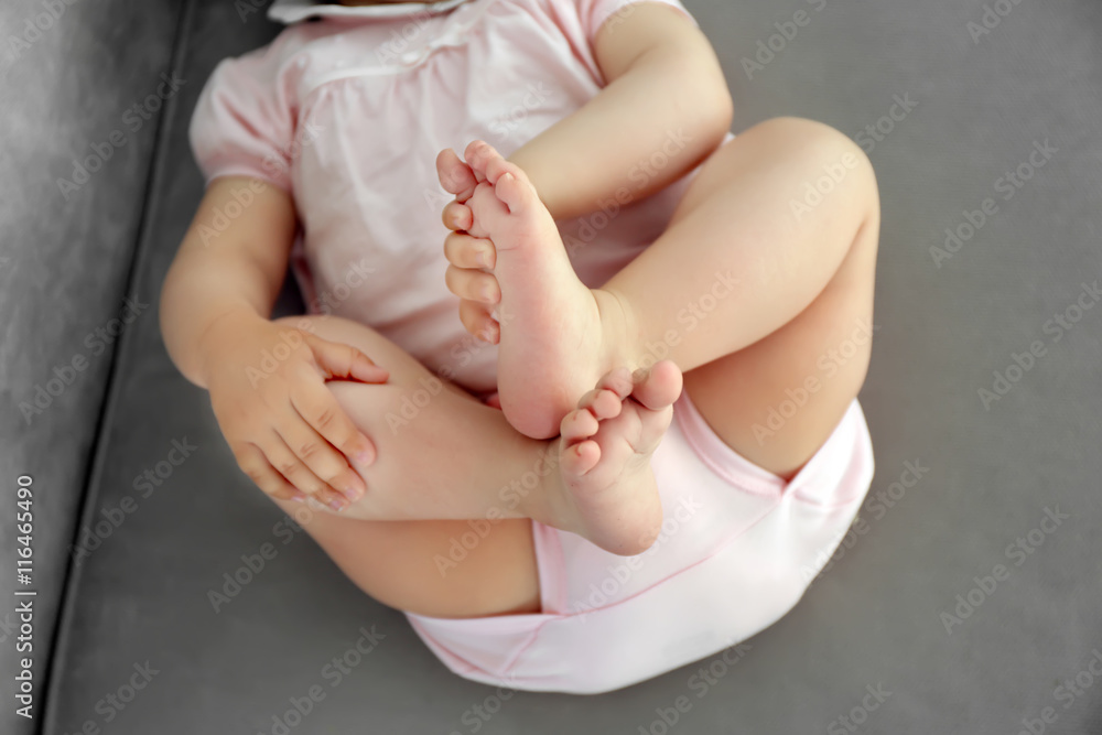 Baby laying on sofa, closeup