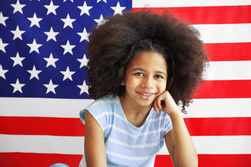 Wall Mural - Afro-American girl on American flag background