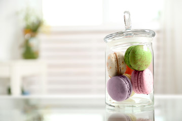 Wall Mural - Colorful macaroons in glass jar on table