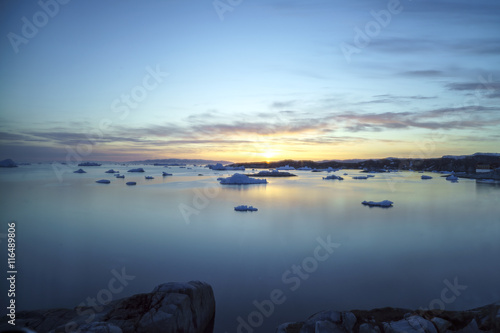 Fotografie, Obraz Sunset time on icebergs to ilulissat fjord at Greenland