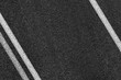 © srzaitsev - Level asphalted road with a dividing white stripes. The texture of the tarmac, top view.