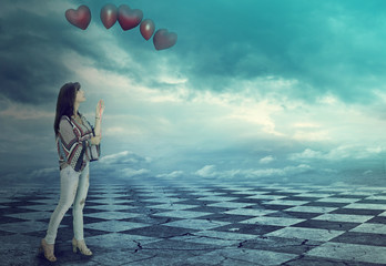 Wall Mural - beautiful woman holding balloons in a magical world