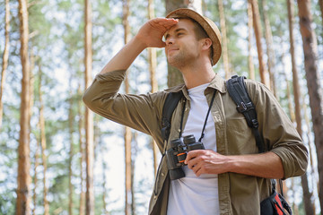 Wall Mural - Joyful male traveler searching for place of destination