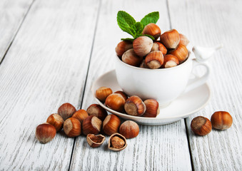 Wall Mural - Cup with hazelnuts