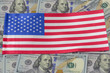 USA flag on the background of dollar banknotes