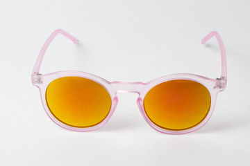 colored summer sunglasses on a white background