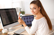 © shefkate - Young woman working in office, sitting at desk