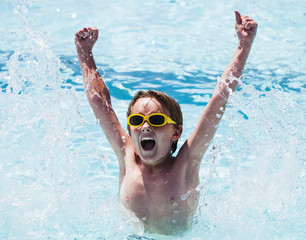 Cheerful boy in swimming pool