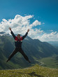 © atomfotolia - Adult man jumped up and yells against the backdrop of the mountains of the North Caucasus