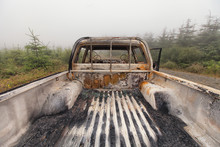 The Back Of A Burnt Out Pick Up Truck Looking Forward