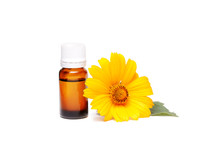 Dark Cosmetic Bottle Of Aromatic Oil For Herbal Medicine With Calendula Flower Isolated On White. Marigold Extract.