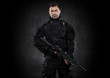 Spec ops police officer SWAT in black uniform studio