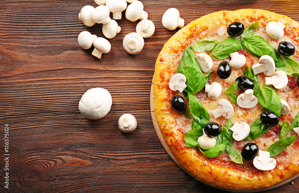 Delicious tasty pizza with ingredients on wooden table