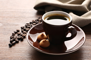 Poster - Cup of coffee with beans on wooden table