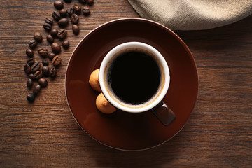 Wall Mural - Cup of coffee with beans on wooden table