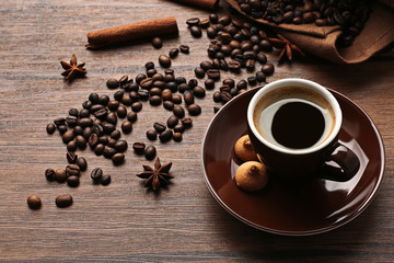 Poster - Cup of coffee with beans on wooden table