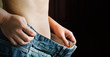 © kazitafahnizeer - women waist with little belly and loose denim jeans