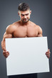 © kegfire - bodybuilder with blank white poster