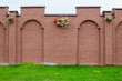 brick wall with flower pots/brick wall with flower pots on a green grass
