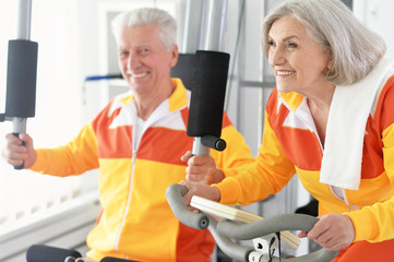 Sticker - senior couple exercising in gym