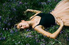 Girl Lying On The Grass And Flowers