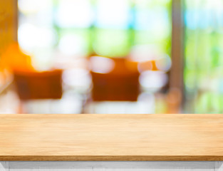 Poster - Empty wooden table top with blurred cafe bokeh light as backgrou