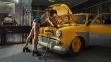Sexy Woman Is Welding Something Inside An Old Car.