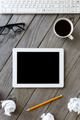 White tablet with blank screen in a home office