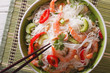 Thai salad with glass noodles, prawns and vegetables macro. Horizontal top view

