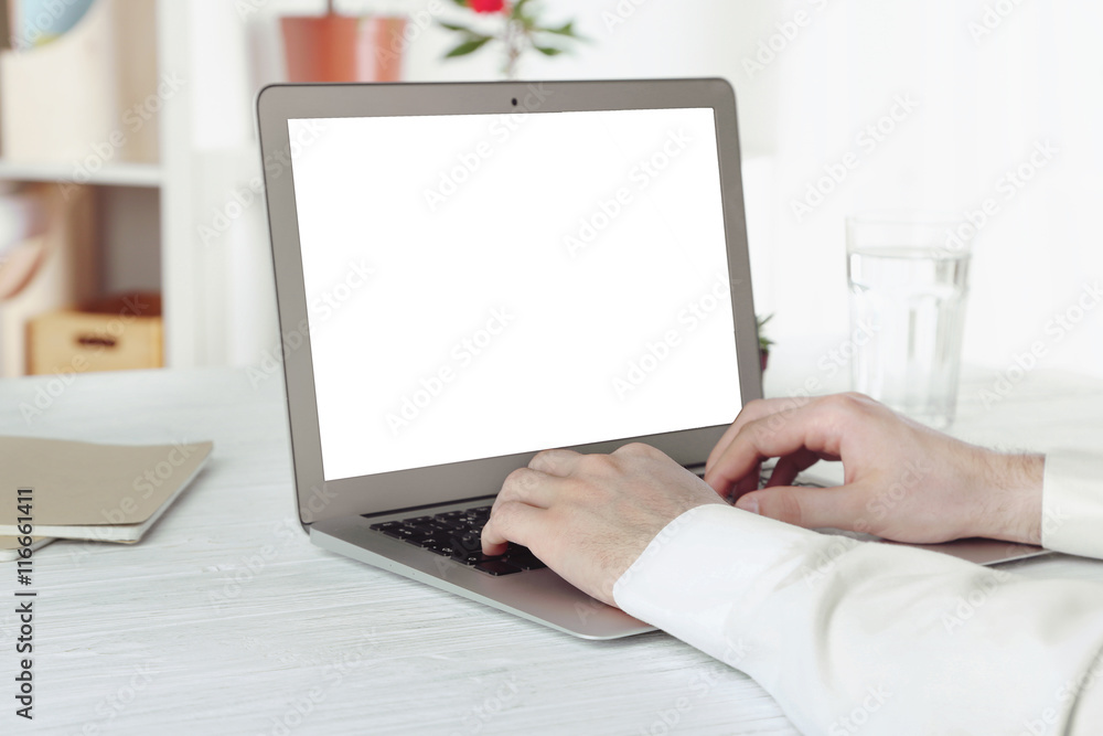Businessman working on laptop indoors