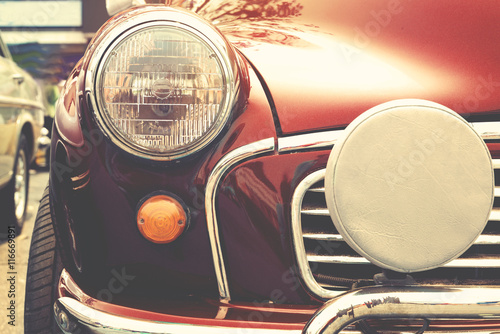 Fotografia, Obraz Headlight lamp of vintage car - retro color effect style