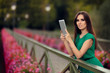 Woman with Digital Tablet on a Bridge with Flowers