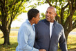 © digitalskillet1 - African American father and son talking.
