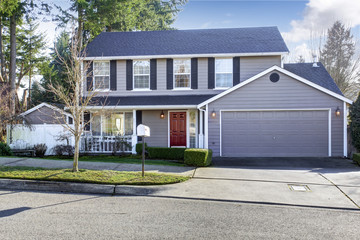 Blue gray house with french windows and red entrance door