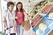 Senior woman going to grocery store with help of carer