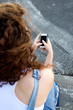 © mimagephotos - Young girl from behind holding cellphone and texting