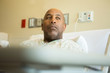© digitalskillet1 - African American man in a hospital bed.