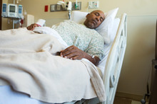 African American Man In A Hospital Bed.