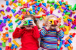 © famveldman - Children playing with colorful blocks.