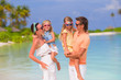 © travnikovstudio - Happy beautiful family on white beach vacation