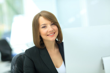 Beautiful business woman dreaming while working on computer at h