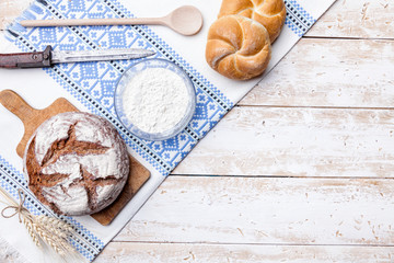 Wall Mural - Delicious fresh bread on wooden background