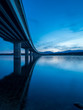 Long bridge over a lake with still water at evening