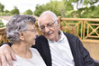 © goodluz - Portrait of elderly couple relaxing outside senior home